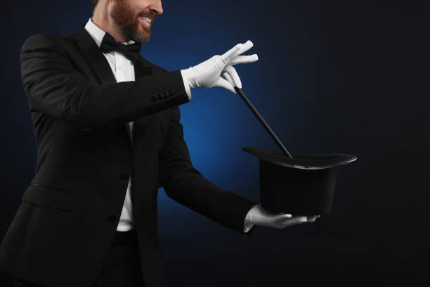 istock Magician showing magic trick with top hat on dark blue background, closeup 1890658345