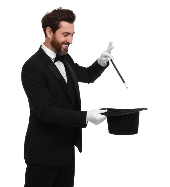 istock Happy magician showing magic trick with top hat on white background 1890659949