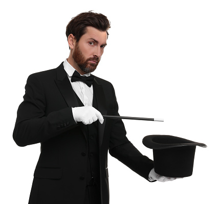 Magician showing magic trick with top hat on white background