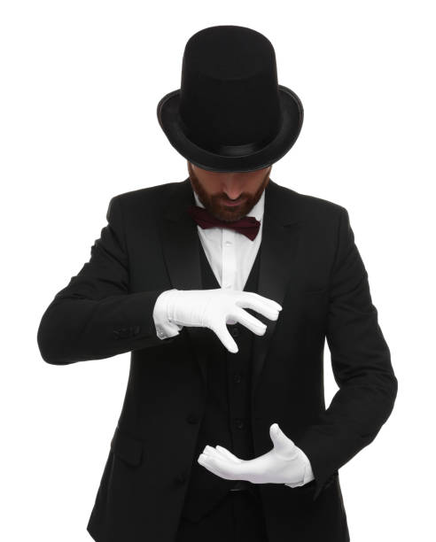 istock Magician in top hat holding something on white background 1890659955