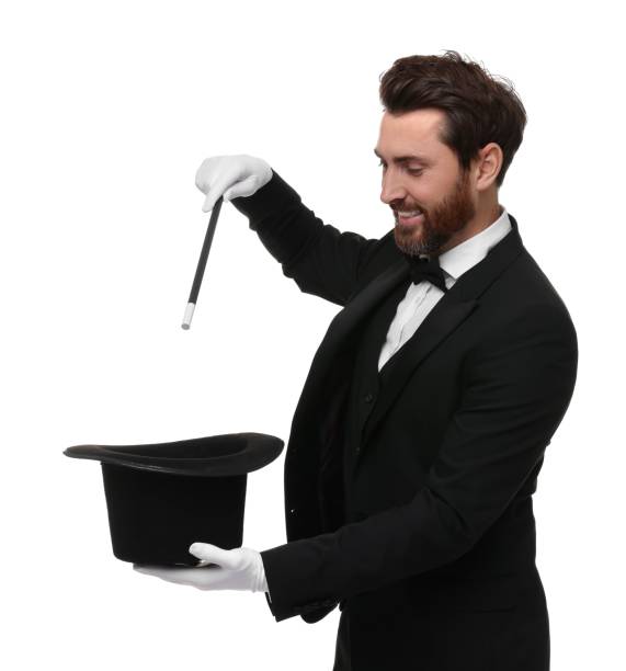 istock Happy magician showing magic trick with top hat on white background 1890660965