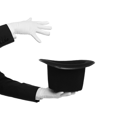 Magician showing magic trick with top hat on white background, closeup