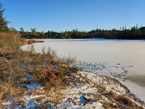 Falun - March 30, 2018: Frozen lake entrance at Framby Udde near the town of Falun in Dalarna, Sweden