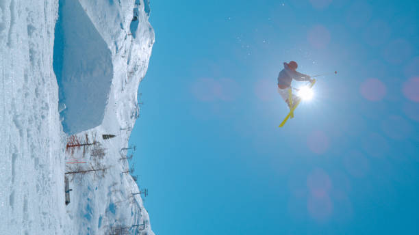 istock LOW ANGLE VIEW: Young male skier flies through the air and performs grab trick 1890666671
