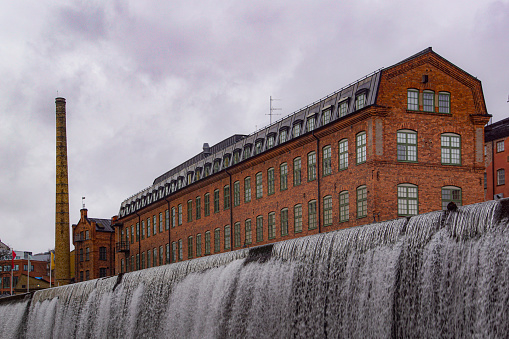 A building by a waterfall against the sky