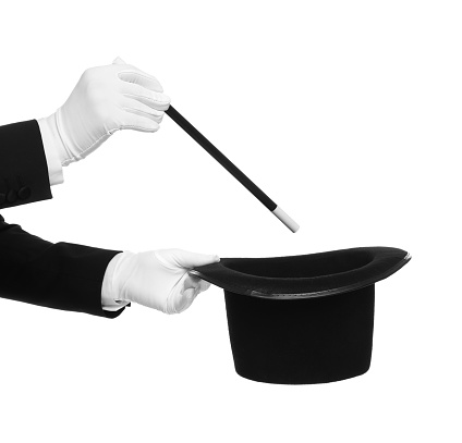 Magician showing magic trick with top hat on white background, closeup