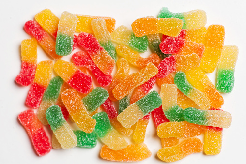 Colorful fruit gelatin candy on white background