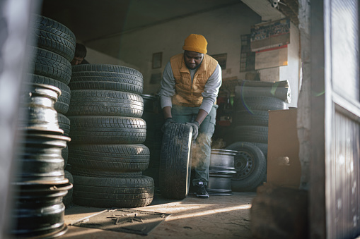 Young Man working in a tire factory