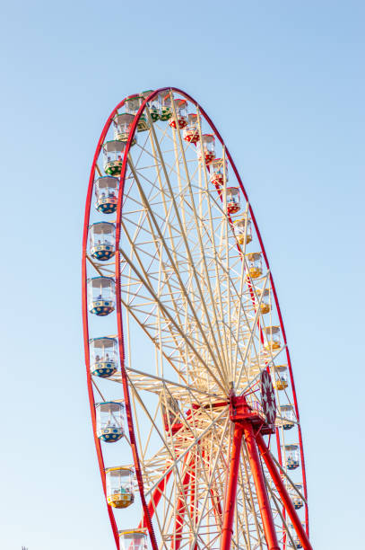 istock Red ferris wheel over blue sky 1890757233