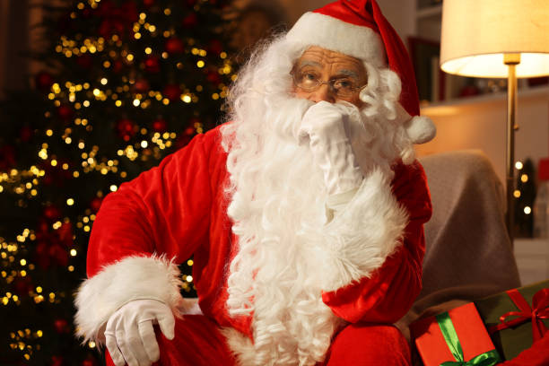 istock Santa Claus sitting in room with Christmas tree 1890758269