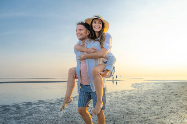 istock Couple piggyback on sand beach 1890797531
