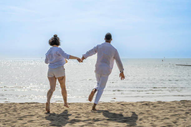 istock Happy couple running on beach 1890797822
