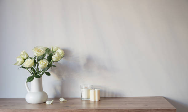 istock white roses in white jug in white interior 1890798469