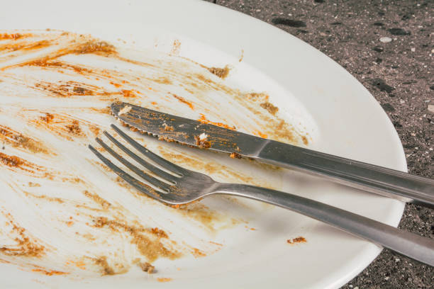 istock Empty white food plate after the meal on a stone table. 1890892399