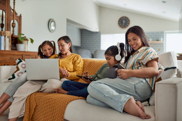 family using technology together - senior adult digital tablet domestic life learning стоковые фото и изображения