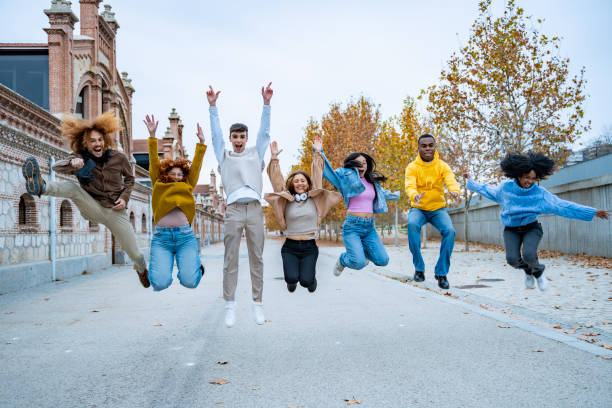 istock Ecstatic friends jumping with joy in an alley 1890895145