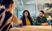 Diverse business professionals meeting around table for important discussion