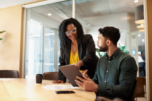 istock Two business professionals having a meeting in a conference room. 1890897787