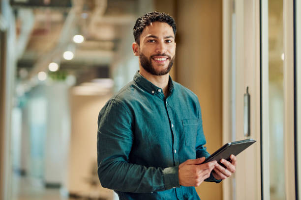 istock Confident Businessman Holding Tablet Smiling at Camera 1890898294