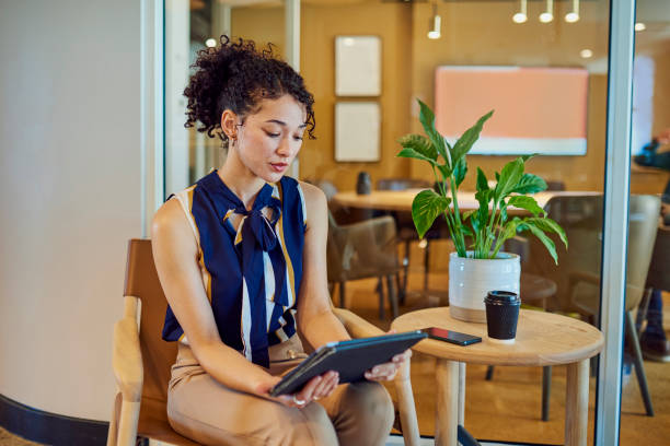 istock Businesswoman analyzing data on tablet in modern office 1890898318