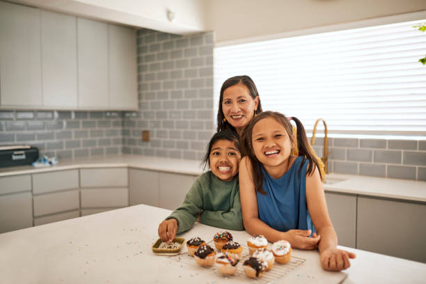 portrait of a happy family baking together in the kitchen - domestic kitchen senior adult built structure candid imagens e fotografias de stock