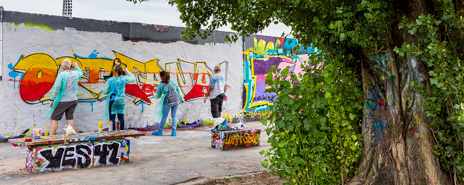 Berlin, Germany - July 23, 2023: Graffiti artist at Mauerpark in Berlin's Prenzlauer Berg district in Berlin in Germany.