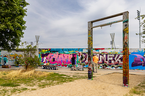 Berlin, Germany - April 24, 2011: East Side Gallery wall of Berlin Germany. Graffiti paintings on the Berlin wall that are part of the East Side Gallery,it is a long section of the original Berlin wall that has been transformed in a freedom memorial. Around 100 artists from all over the world painted in 1990 this section of the wall. The paintings are now restored after they suffered badly from vandalism that damaged badly the original ones.This graffiti is by artist Kim Prisu.