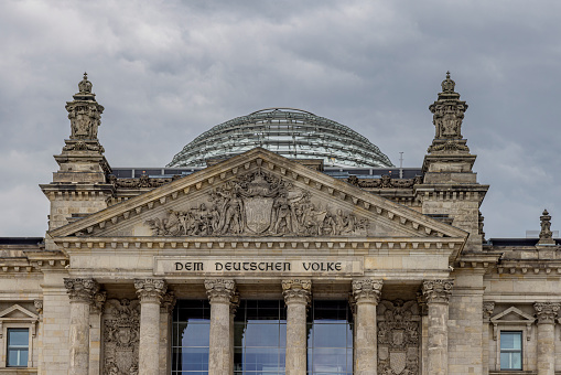 A close up picture of the German Parlament also knows as the Bundestag. The building itself is known as the Reichstag. The text \