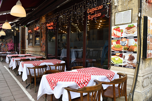 Istanbul, Turkey - December 11, 2023: Empty street cafe on Sehid Mehmet Pasha in historical part of city at early morning