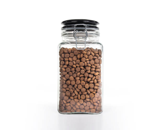 istock Isolated glass jar with kibbles, treats or snacks 1890989454