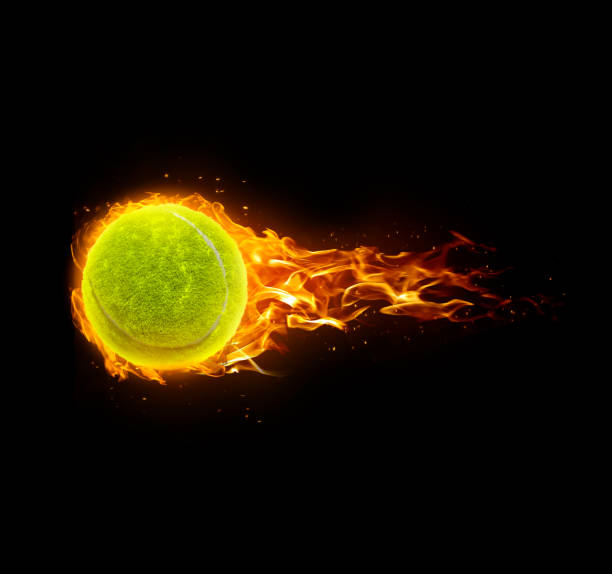 istock Tennis ball, on fire on black background 1891071102