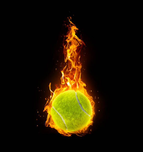 istock Tennis ball, on fire on black background 1891071105