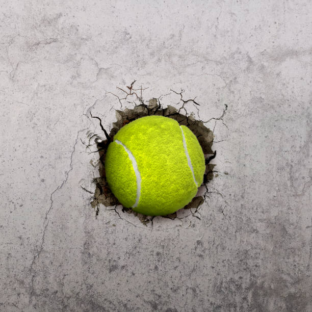 istock Tennis ball flying through the wall with cracks 1891071111