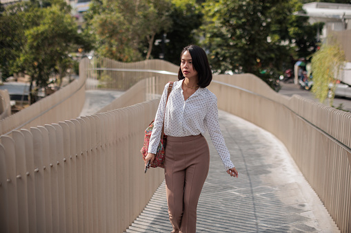 A young businesswoman walks confidently to her office.