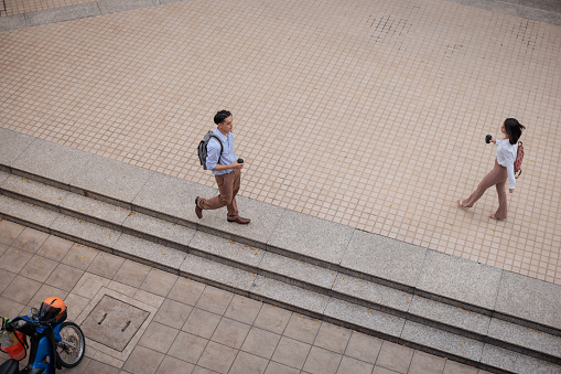 Business people pass by each other on their way to work.