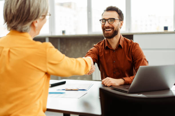 Team smiling confident business people handshake working in office. Human resources, job interview