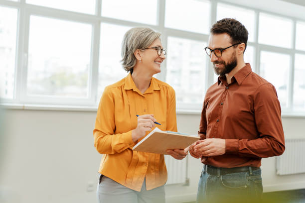 istock Smiling business people, successful colleagues, workers communication, sharing ideas 1891128177