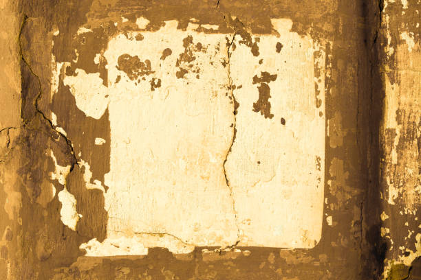 istock Light yellow concrete wall with deep scratches and chips. Various variations of abrasions. 1891169210
