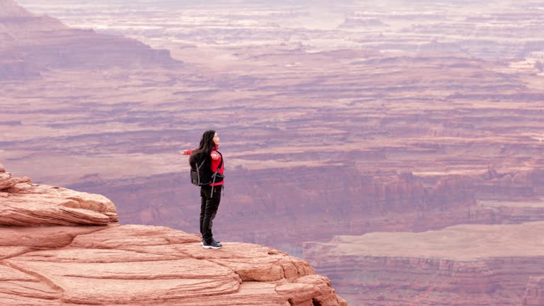 Asian woman hiking through the landscape near Moab