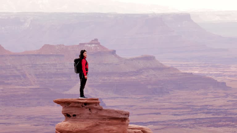 Asian woman hiking through the landscape near Moab