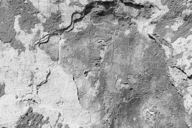 istock Light grey concrete wall with deep scratches and chips. Various variations of abrasions. 1891347684