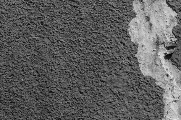 istock Light grey concrete wall with deep scratches and chips. Various variations of abrasions. 1891357585