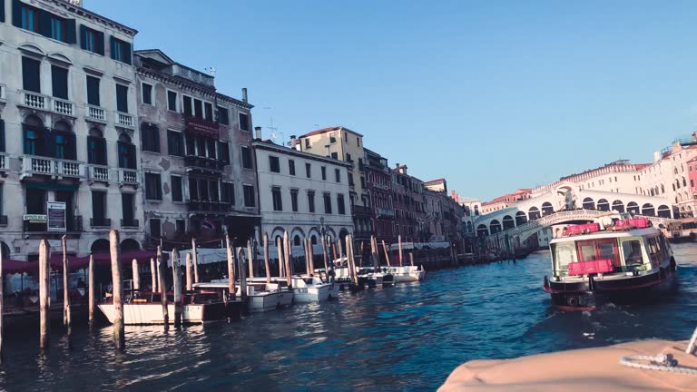 Venice, Italy - March 30, 2021: Grand Canal boat tour at sunset, view from a private moving boat near Rialto Bridge