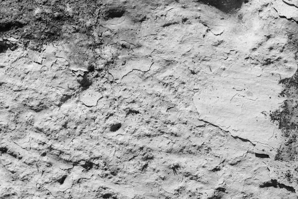 istock Light grey concrete wall with deep scratches and chips. Various variations of abrasions. 1891390094