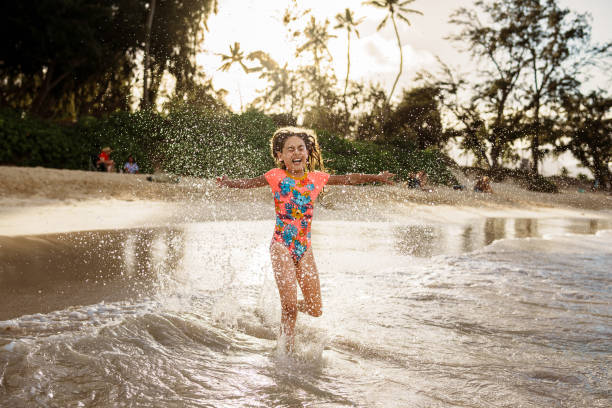istock Happy young girl splashes in the ocean 1891413227