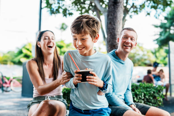 istock Family enjoying Hawaiian shave ice while on vacation 1891413253