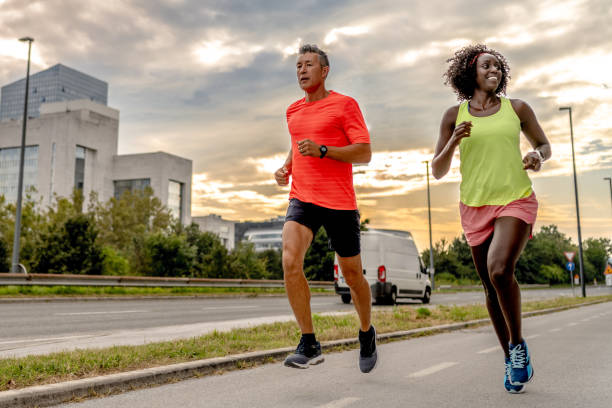 istock Man and woman running on street 1891425307