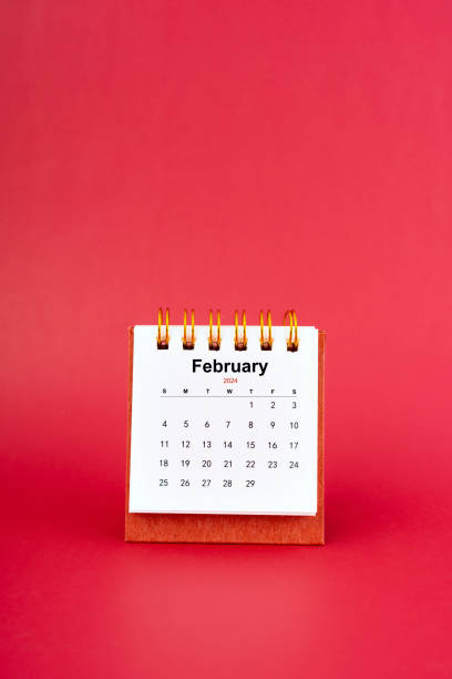 istock February 2024 white mini desk calendar on red background. 1891434953