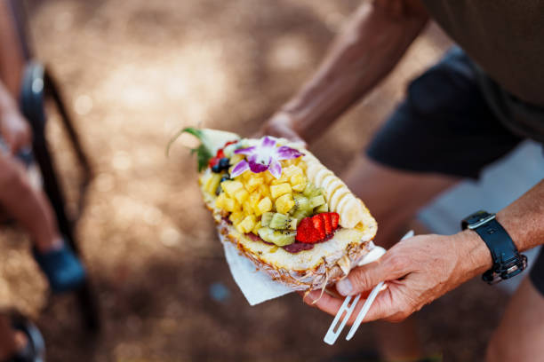 istock Man holds fresh acai bowl during picnic 1891441155