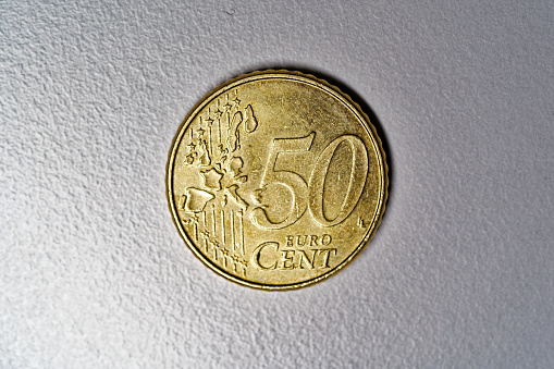 Close-up of golden Euro Cent coin value 50 cents against gray background. Photo taken December 28th, 2023, Zurich, Switzerland.